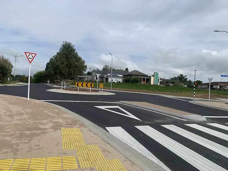 A road with a crosswalk and a road sign